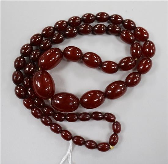 A single strand graduated simulated cherry amber bead necklace, 72cm.